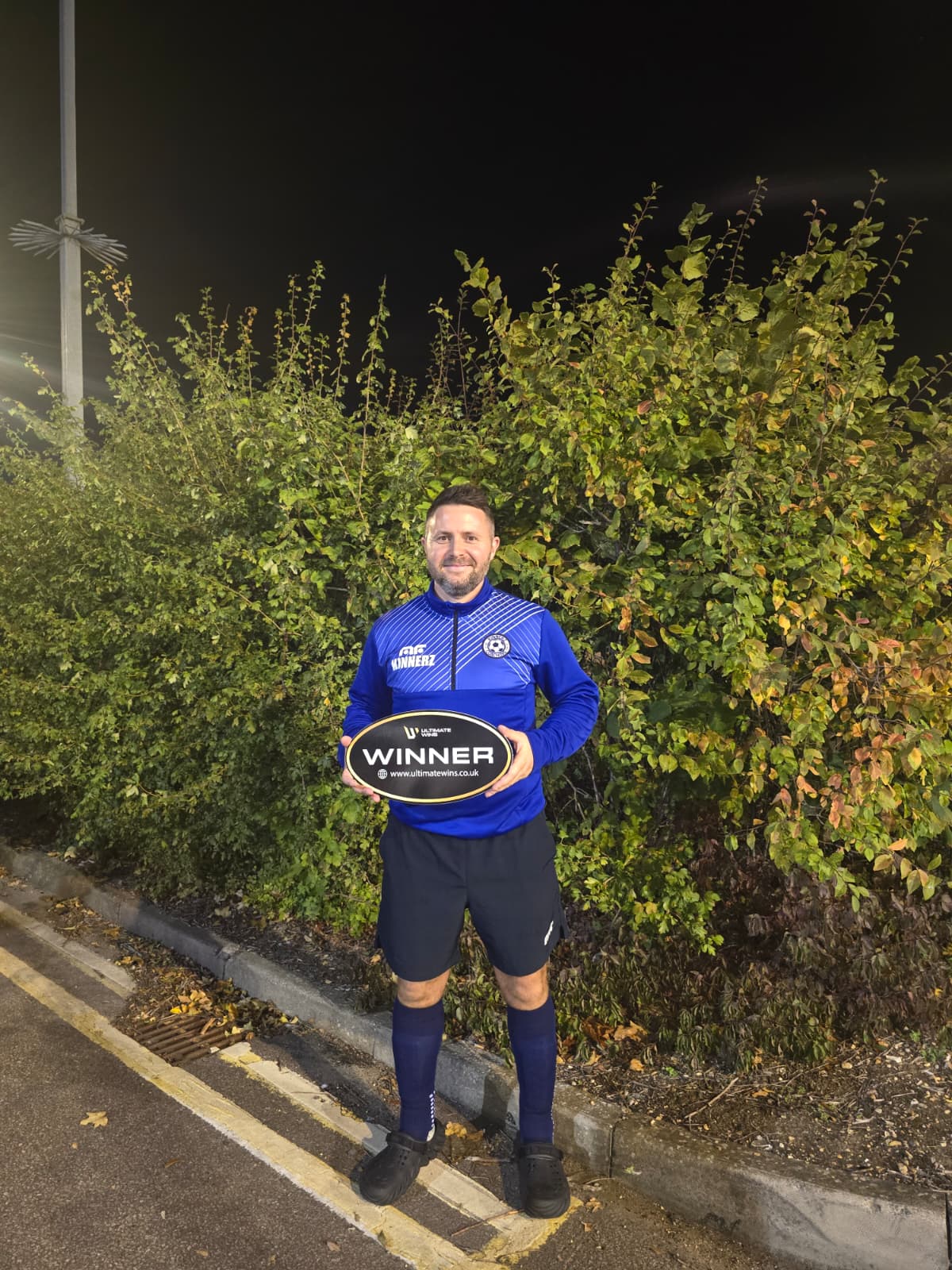 Phil, £500 cash winner, holding the Ultimate Wins winner sign